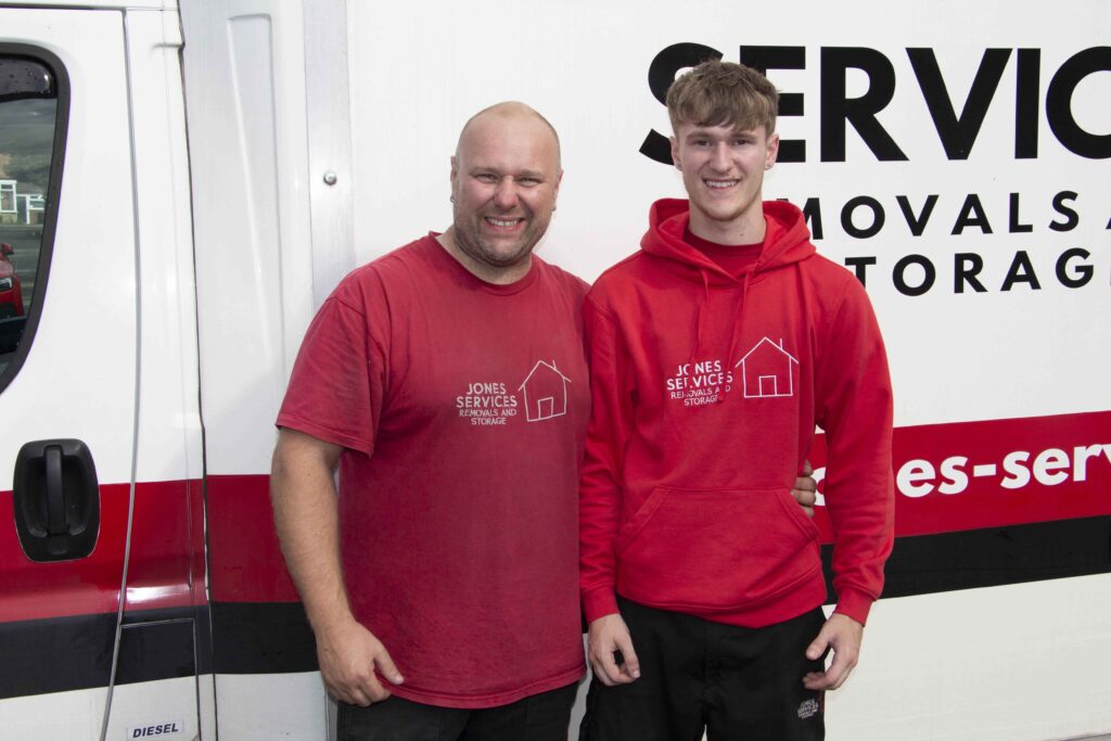 Jones services standing next to each other in front of van